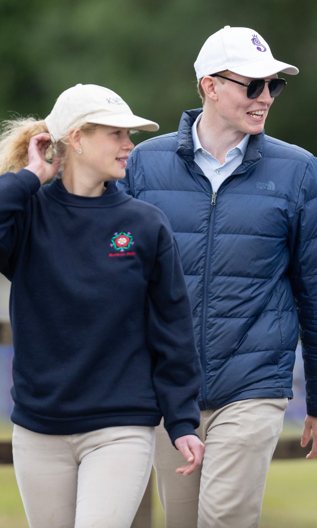 Lady Louise Windsor twirls her hair as she leaves with Felix da Silva-Clamp