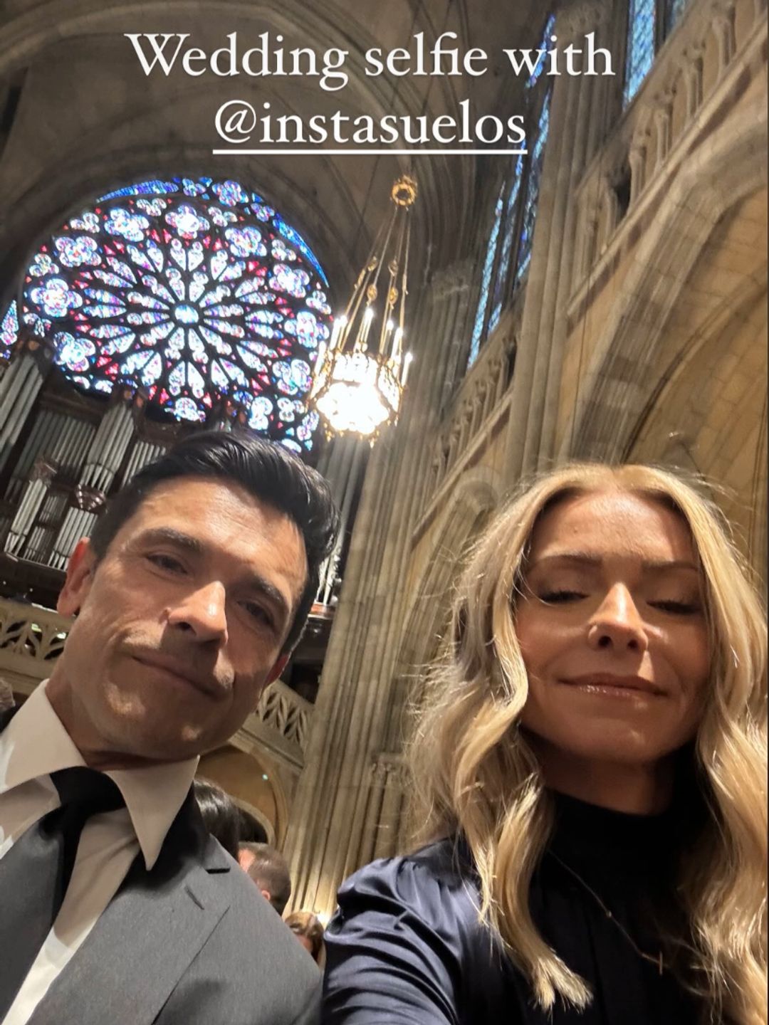 Kelly Ripa and Mark Consuelos taking a selfie inside a church