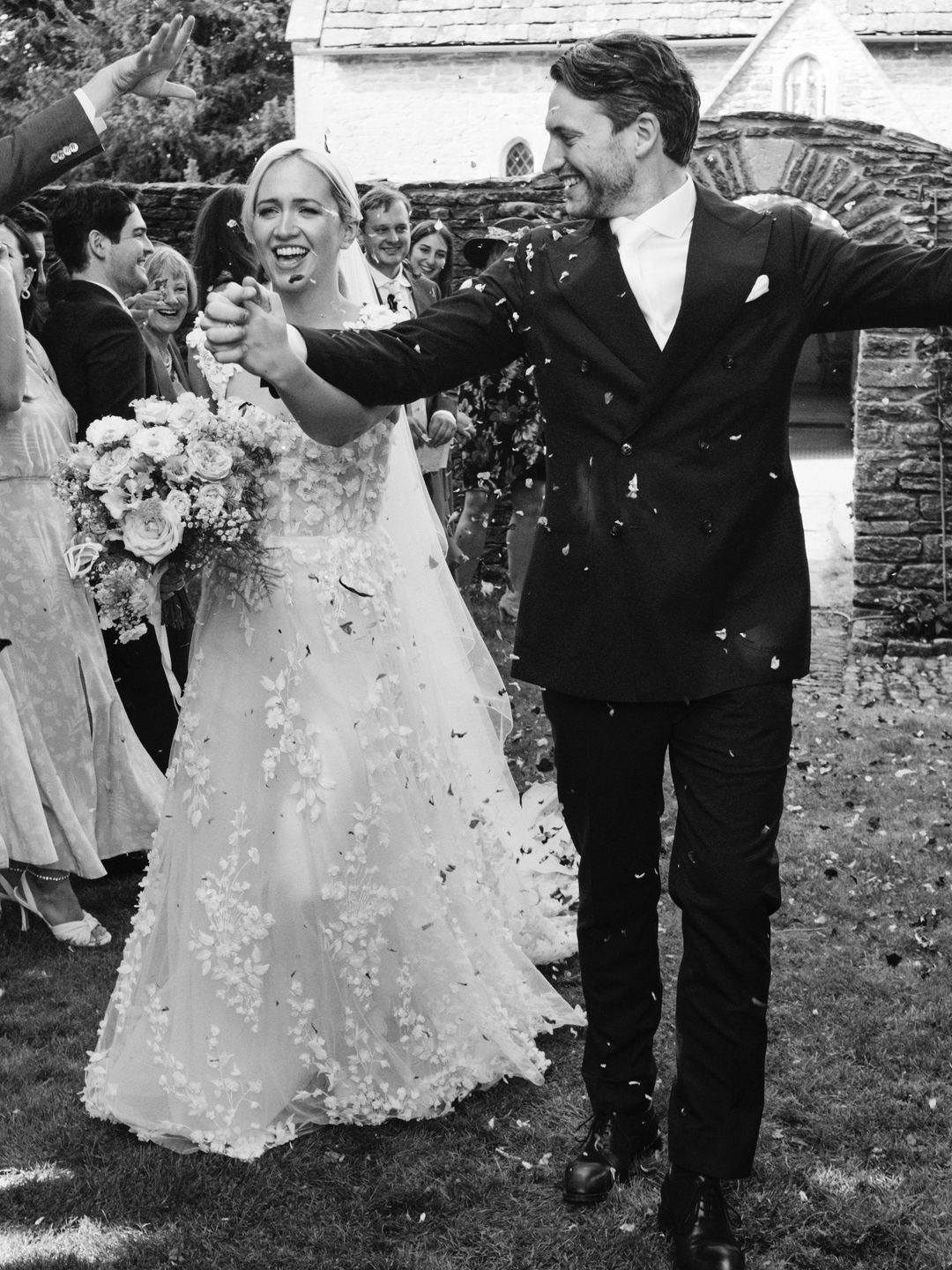 bride and groom hold hand after getting married