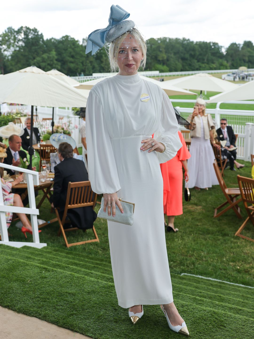 Shoe designer Camilla Elphick attended day two of Royal Ascot wearing dazzling rings from Chupi, a Suki London dress, Awon Golding headpiece, and shoes from her eponymous label, Camilla Elphick.