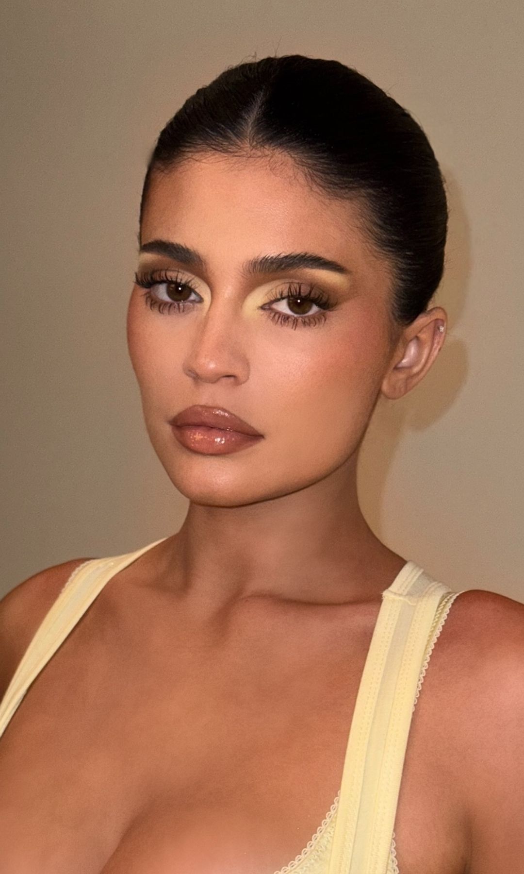 Kylie Jenner poses in a butter yellow dress on her instagram