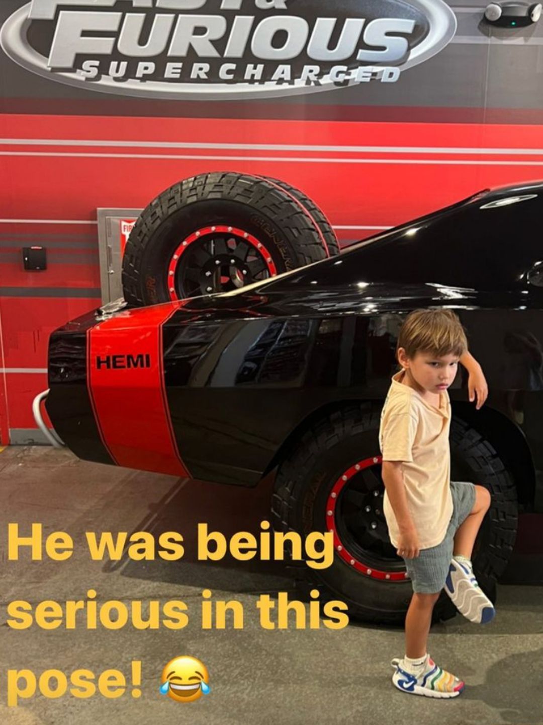 Vanessa's son Phoenix poses for an adorable photo at the Fast and Furious attraction
