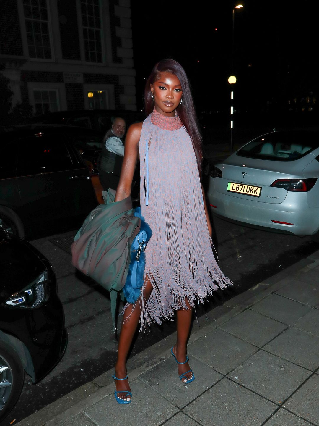 Leomie Anderson dressed to impress at the Burberry afterparty in a lilac-hued fringed dress.