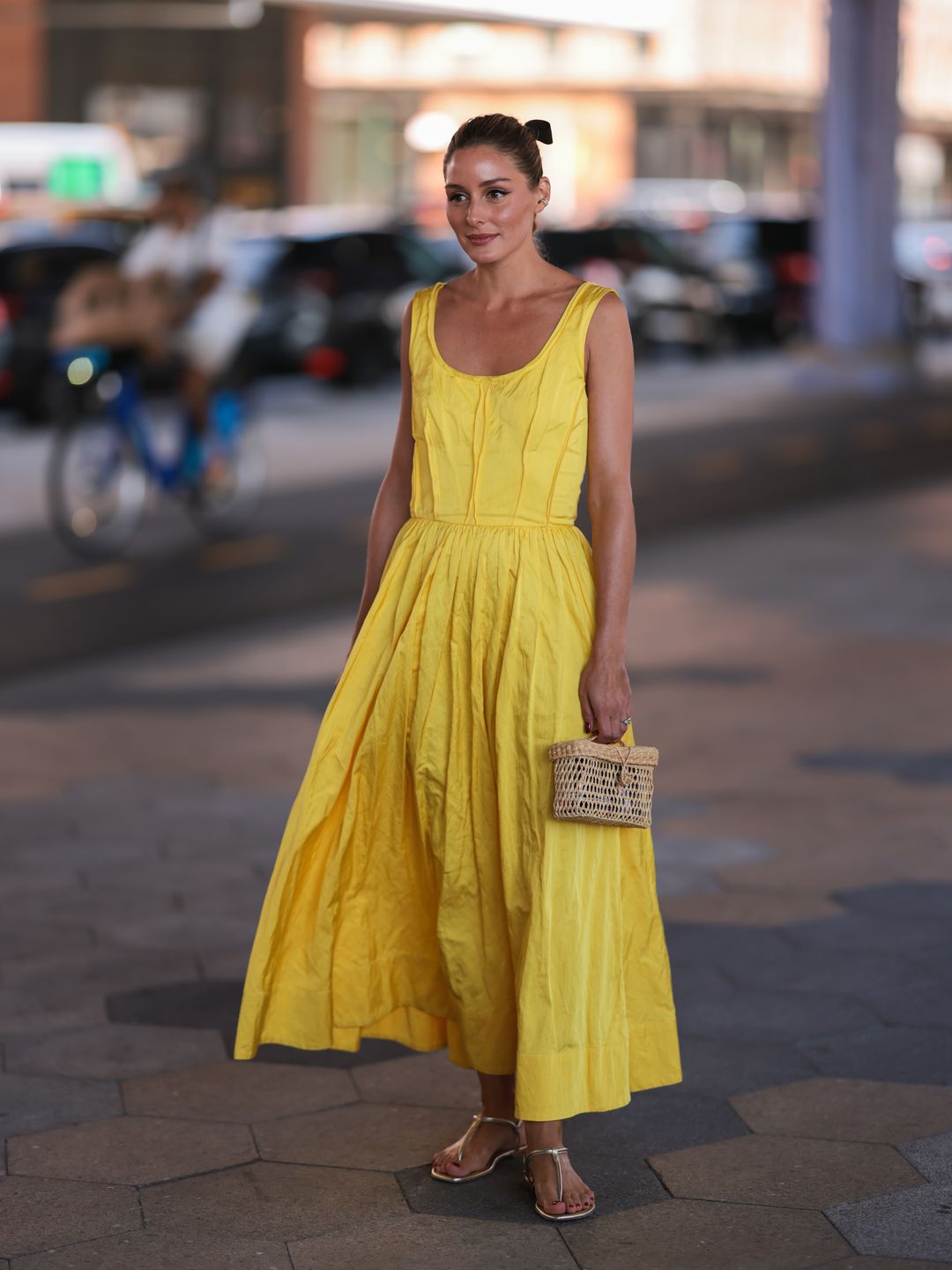 Olivia Palermo wearing a yellow dress holding a raffia bag 