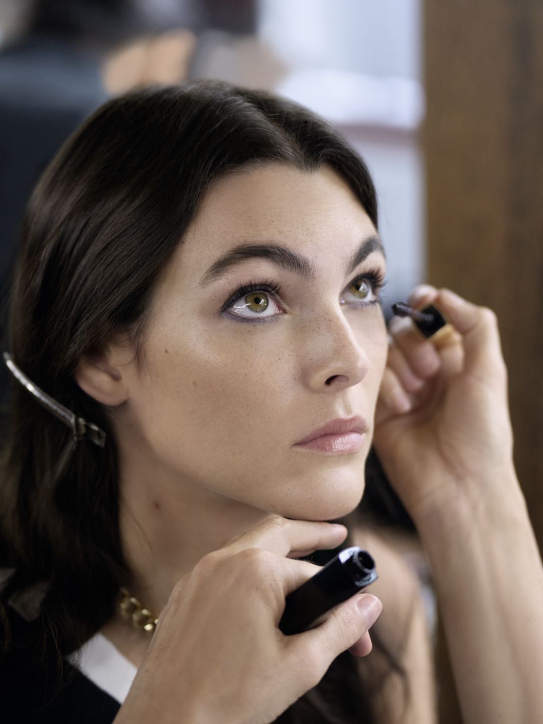 Chanel model having her mascara applied 