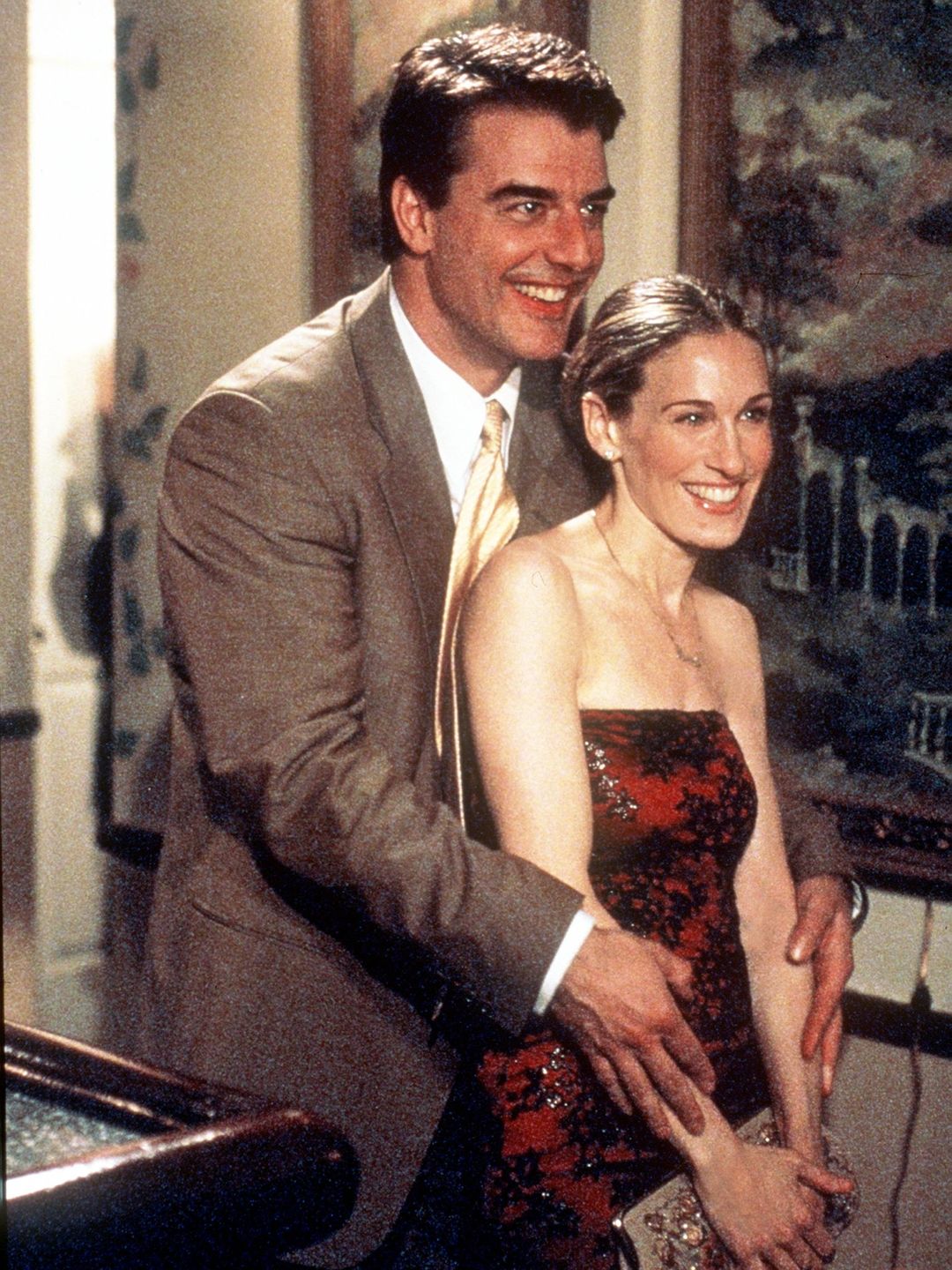 Carrie Bradshaw being hugged from behind by Mr Big 