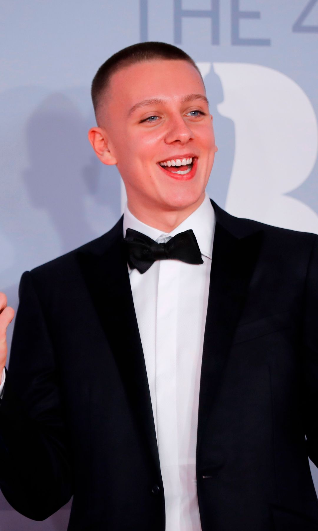 Aitch posing on the red carpet