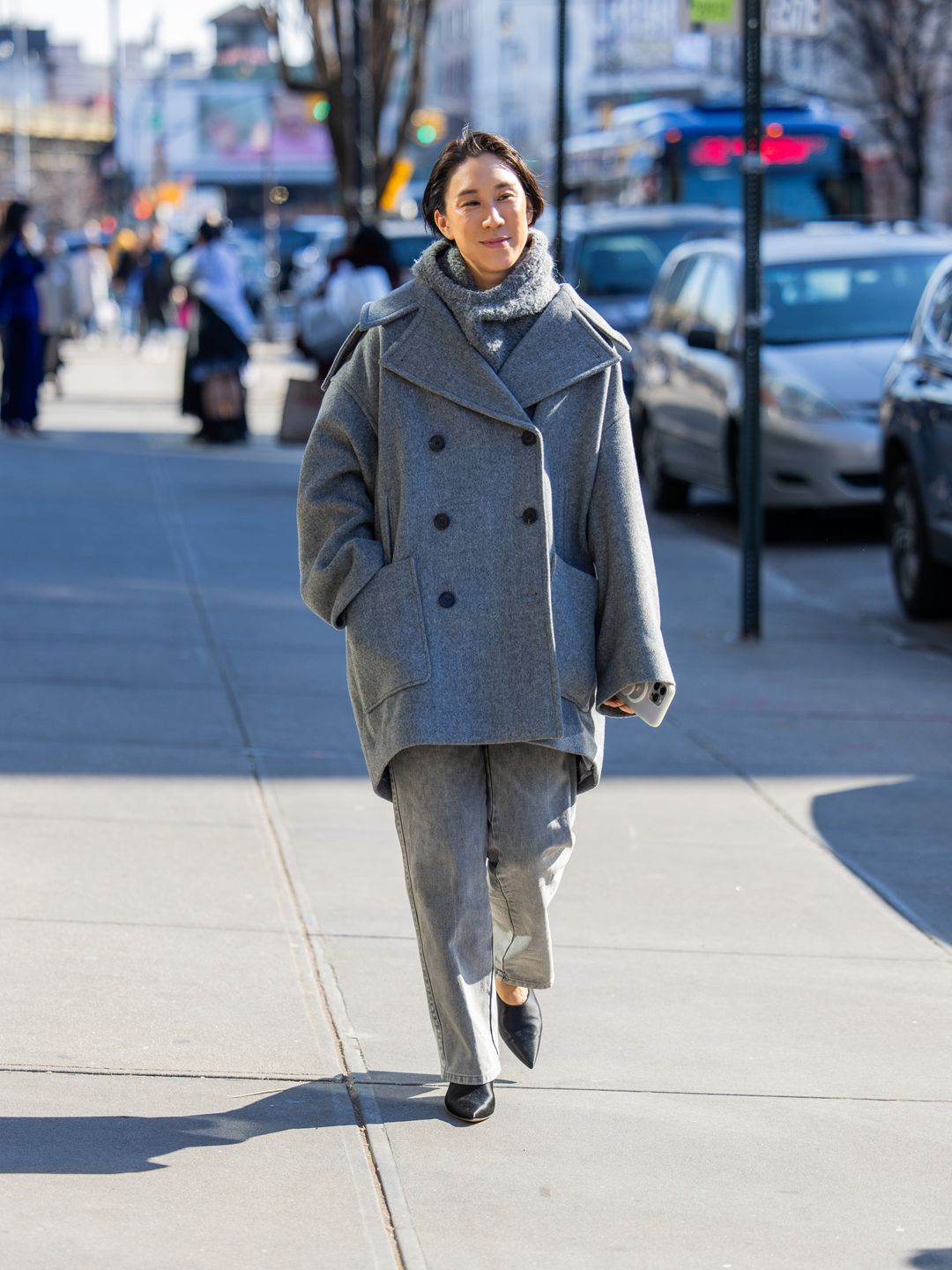 Eva Chen wears oversized grey coat, pants, turtleneck outside Helmut Lang on February 09, 2024 
