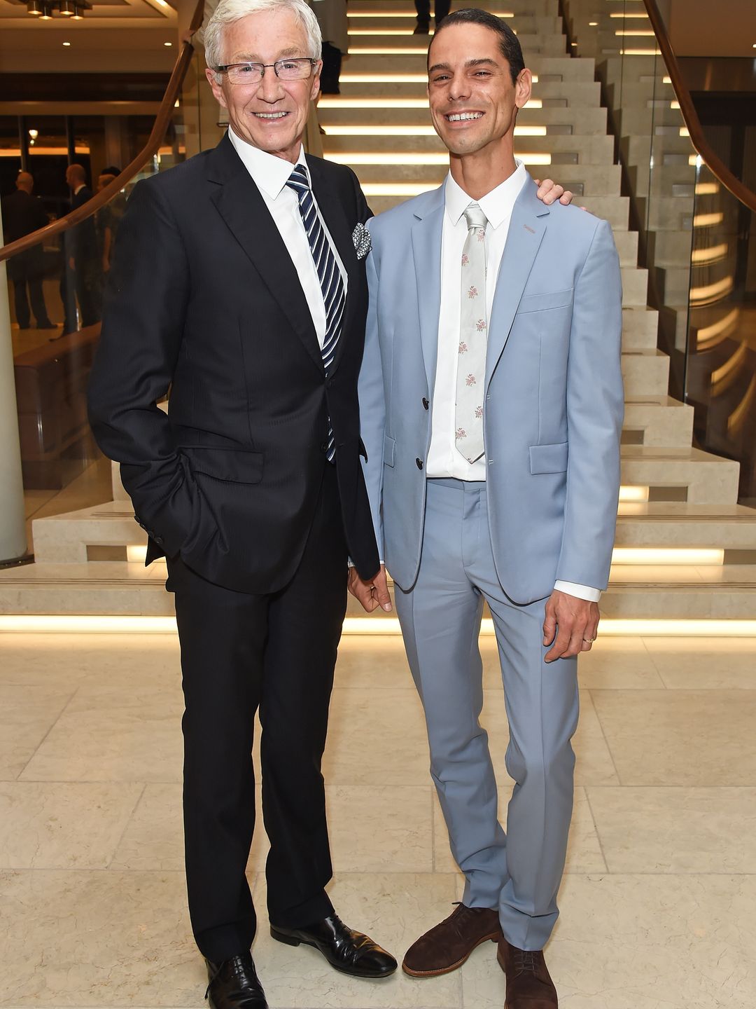 Paul O'Grady with his partner Andre Portasio dressed in suits