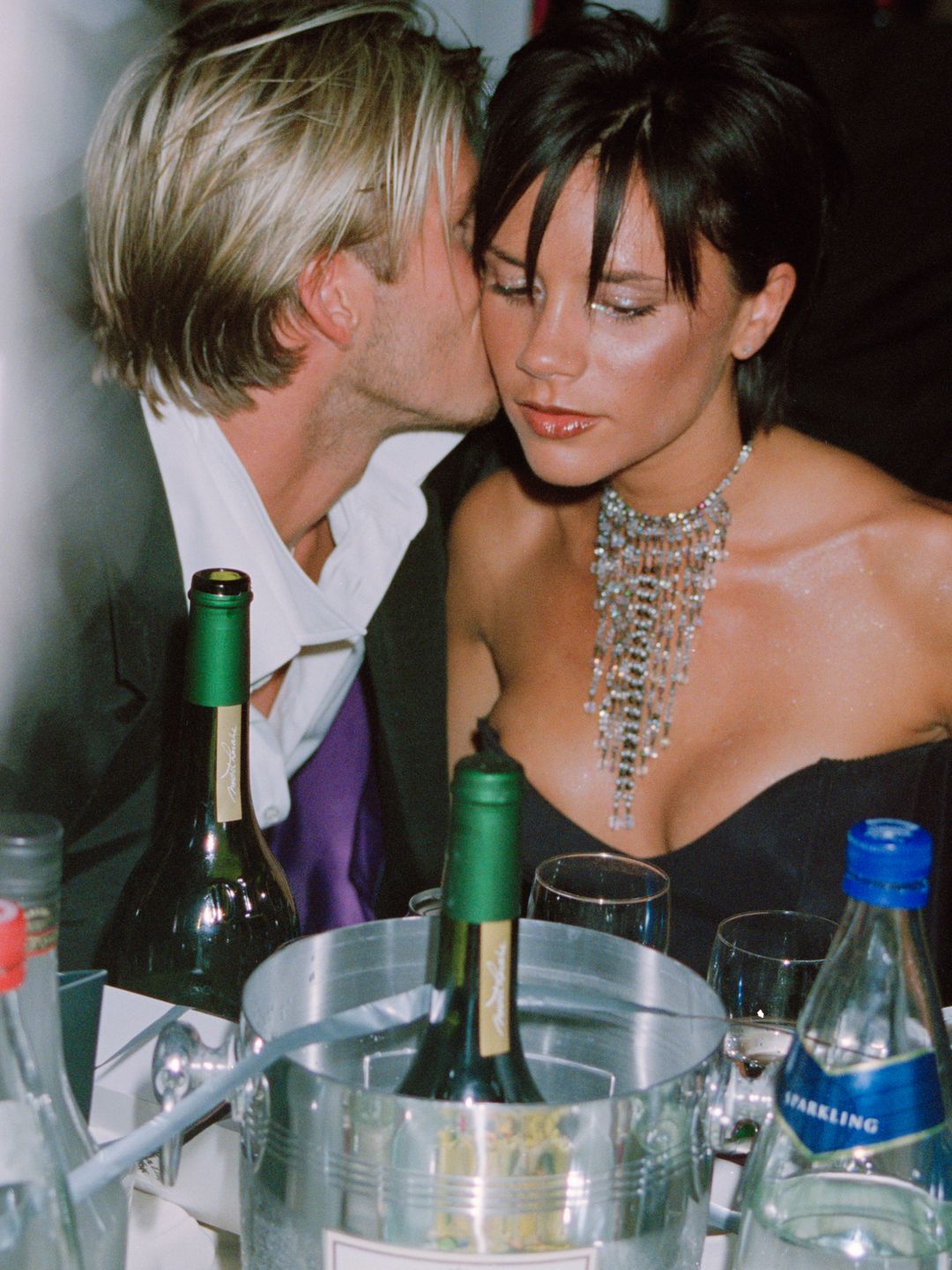 David whispering in Victoria Beckham's ear over dinner