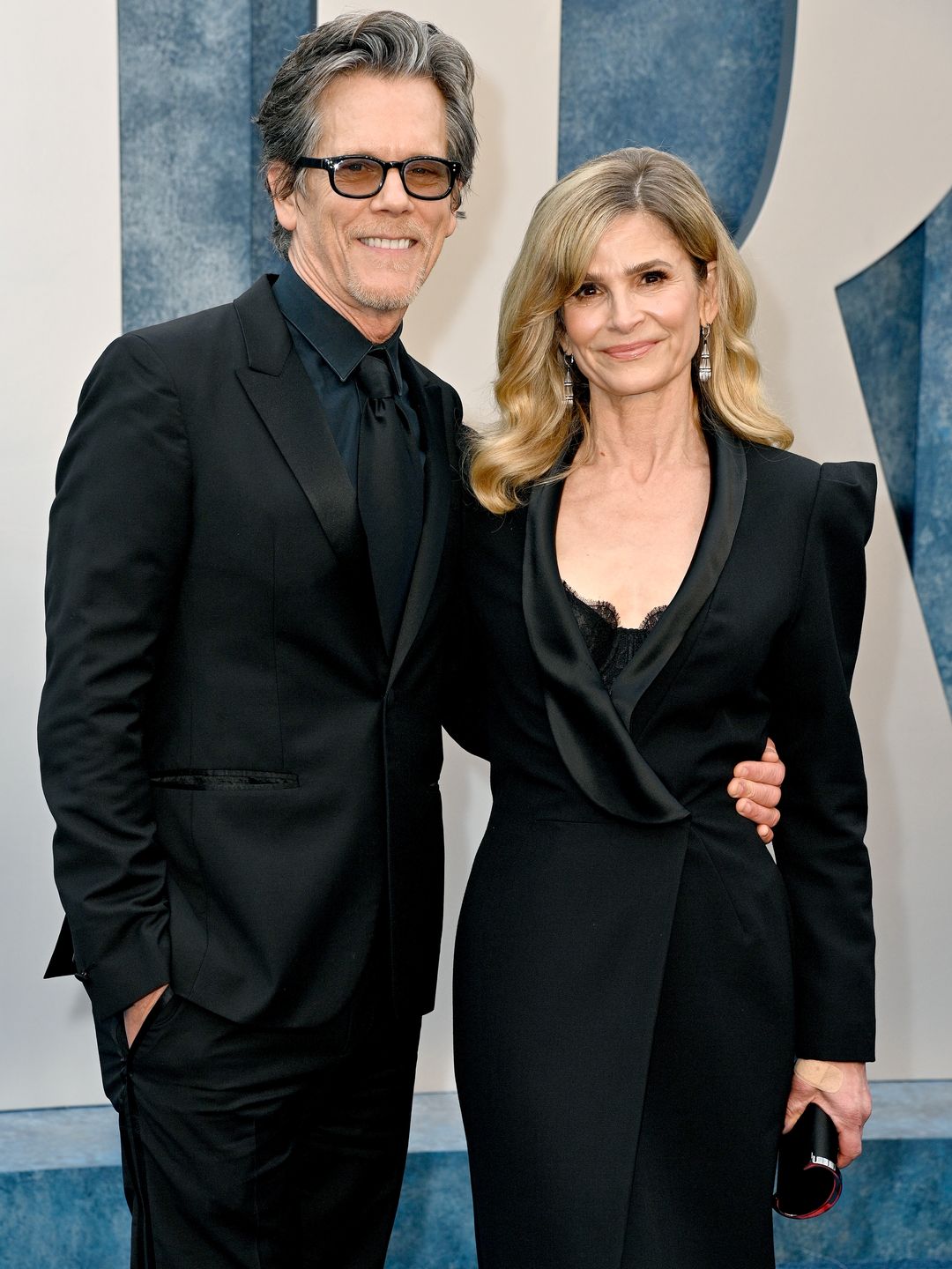Kevin Bacon and Kyra Sedgwick smiling on a red carpet