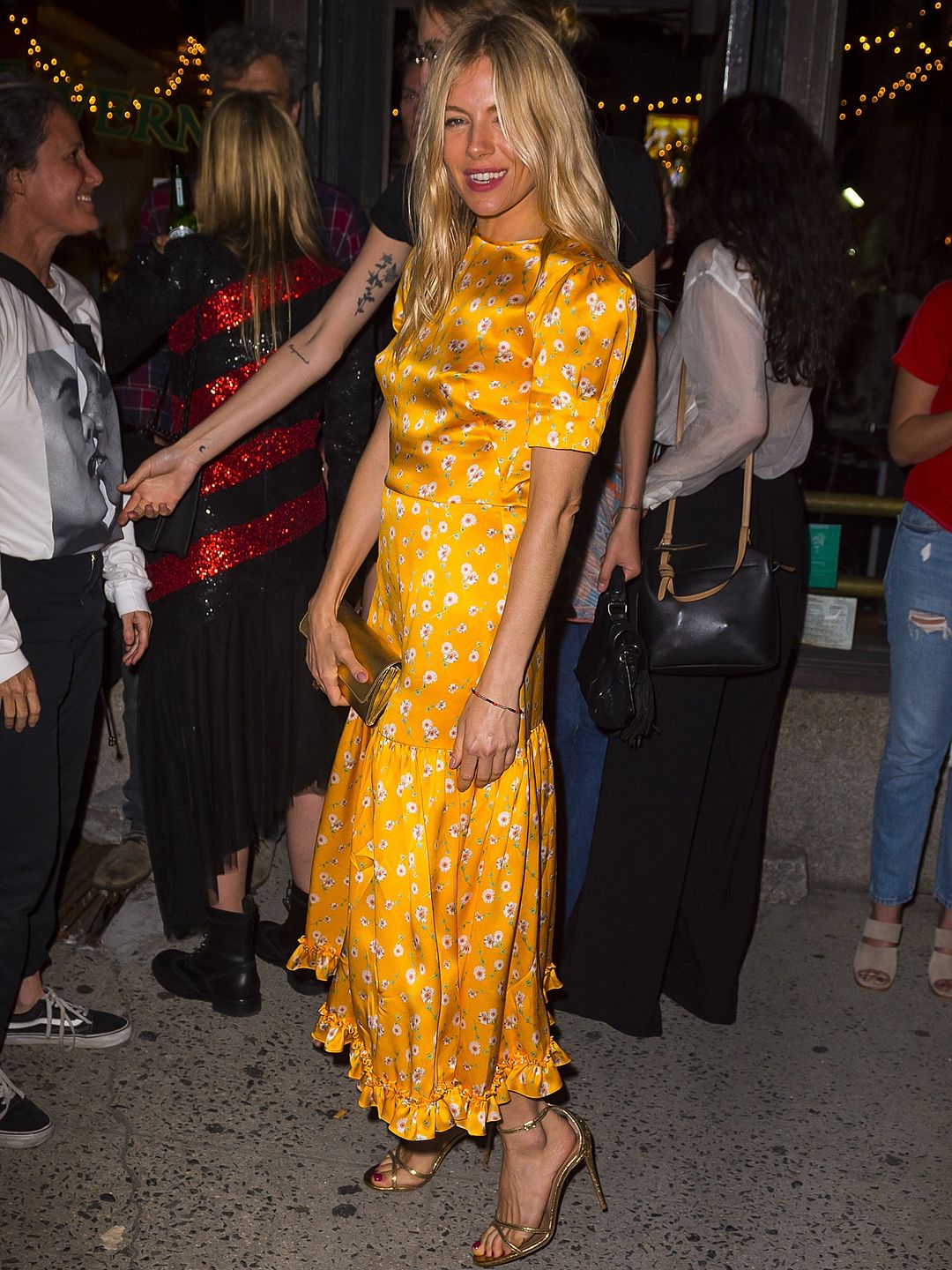 Sienna Miller in a yellow dress