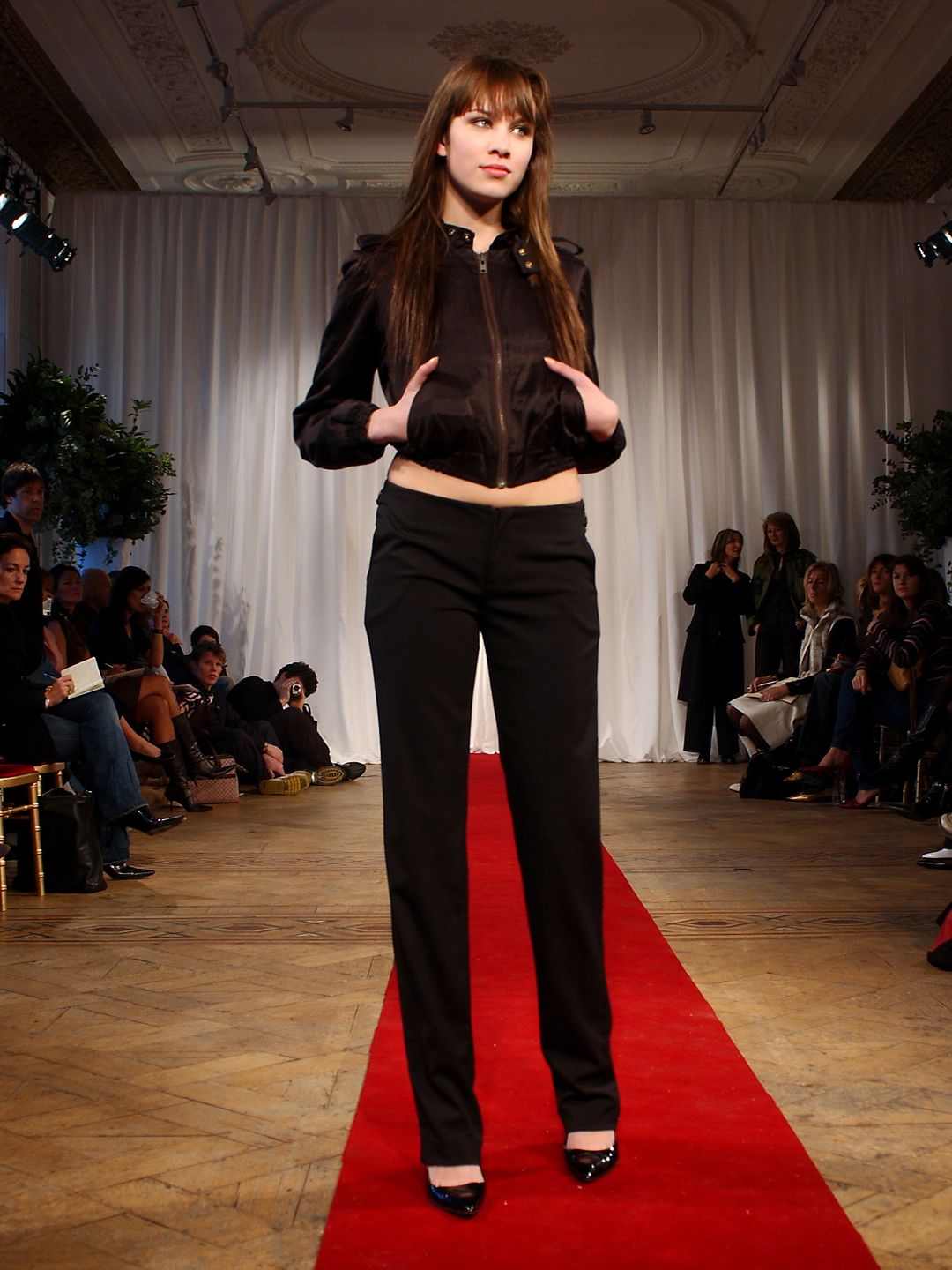 Alexa Chung wears a creation by designer Katharine Hamnett during her autumn/winter 2003 collection catwalk show as part of London Fashion Week at Grosvenor Place in London