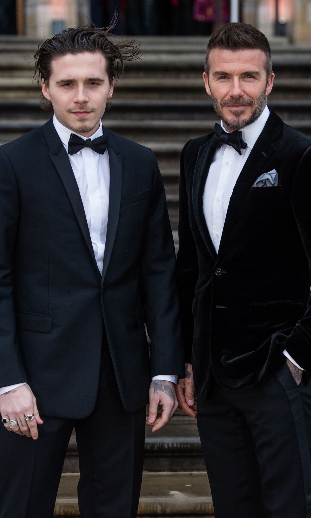 Brooklyn Beckham and David Beckham in black tuxedos