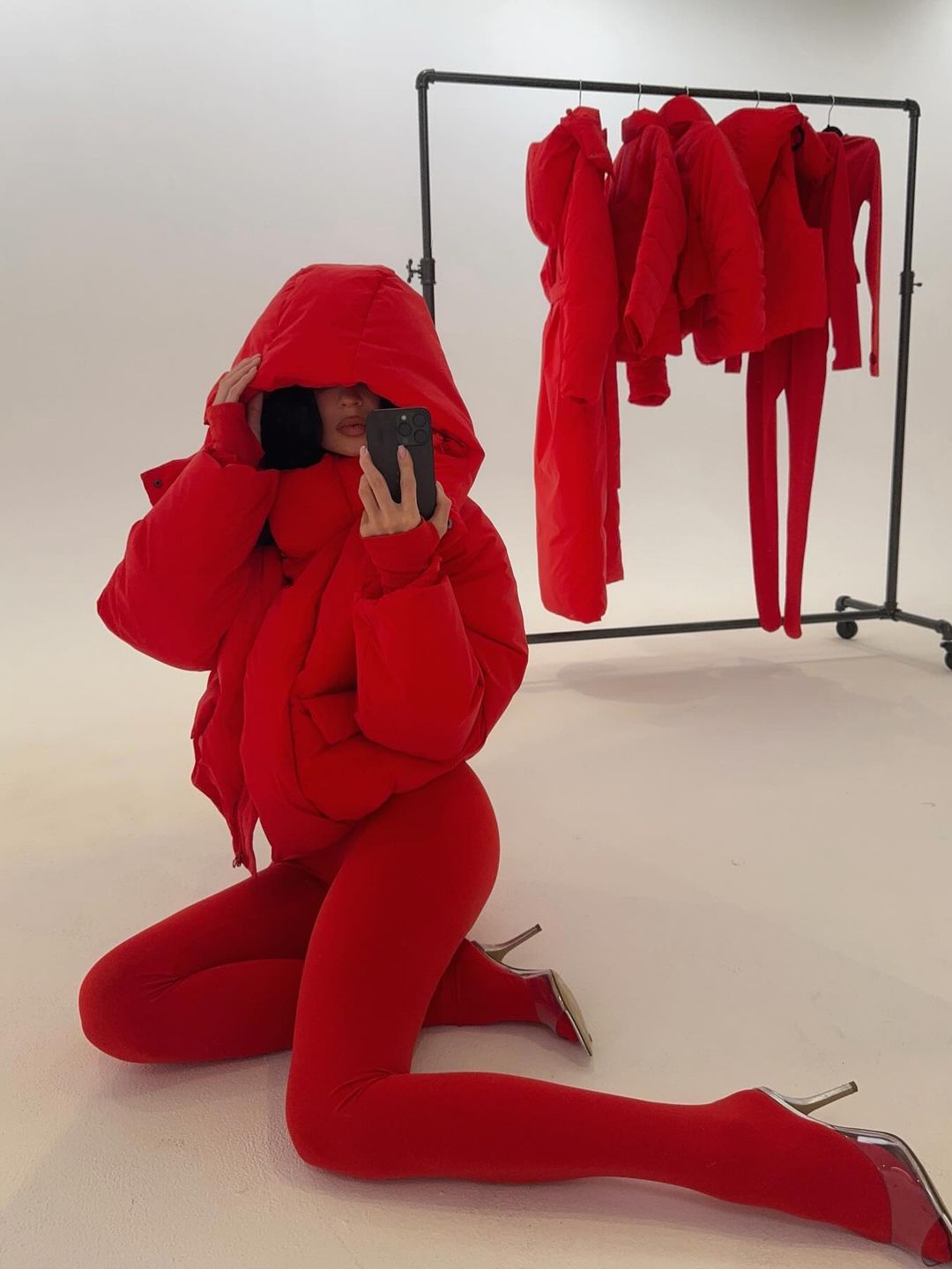 Kylie Jenner poses for a mirror selfie in red tights and a puffer jacket