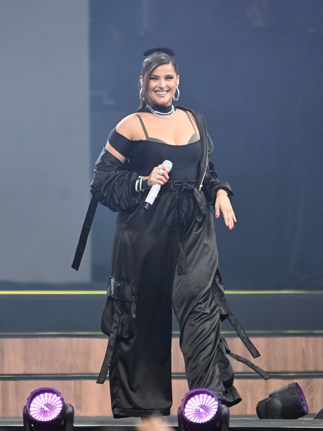 Nelly Furtado performing in a black outfit