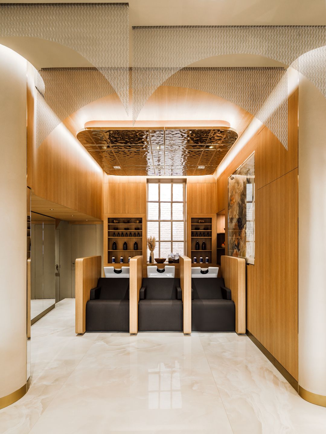 Modern hair washing sinks with wood walls at Michael John Guzzon hair salon