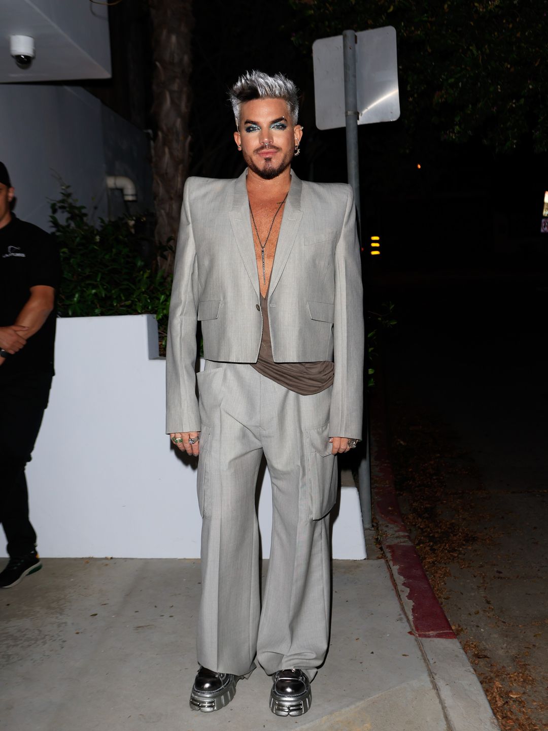 Adam Lambert opted for a grey suit with chunky platforms 