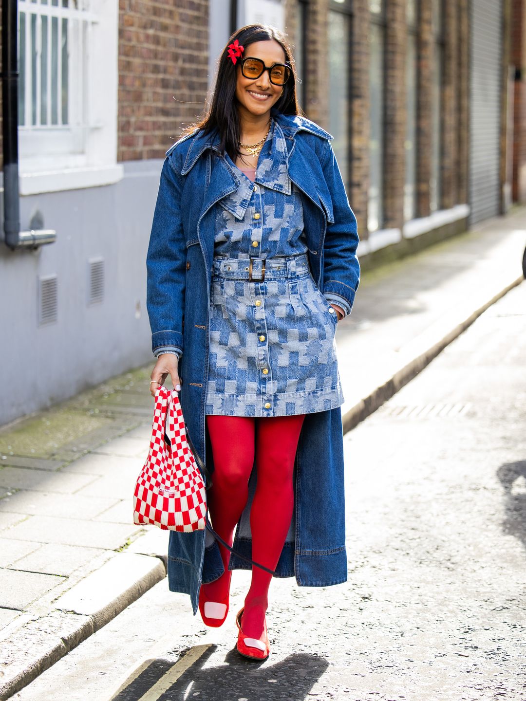 Serial dopamine dresser Zeena donned red tights, a red checkered bag, a denim outfit, and red hair accessories outside Bora Aksu.