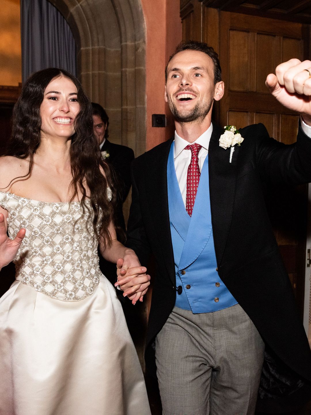 bride and groom hold hands on their wedding day