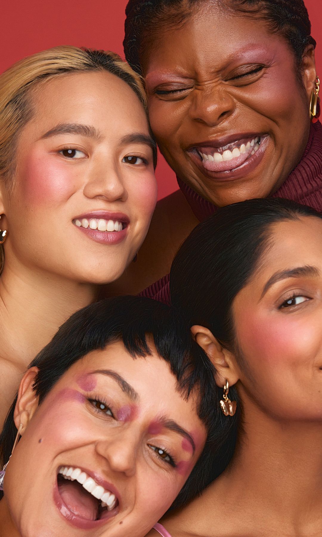 3 women smiling with bright red blush on their cheeks 