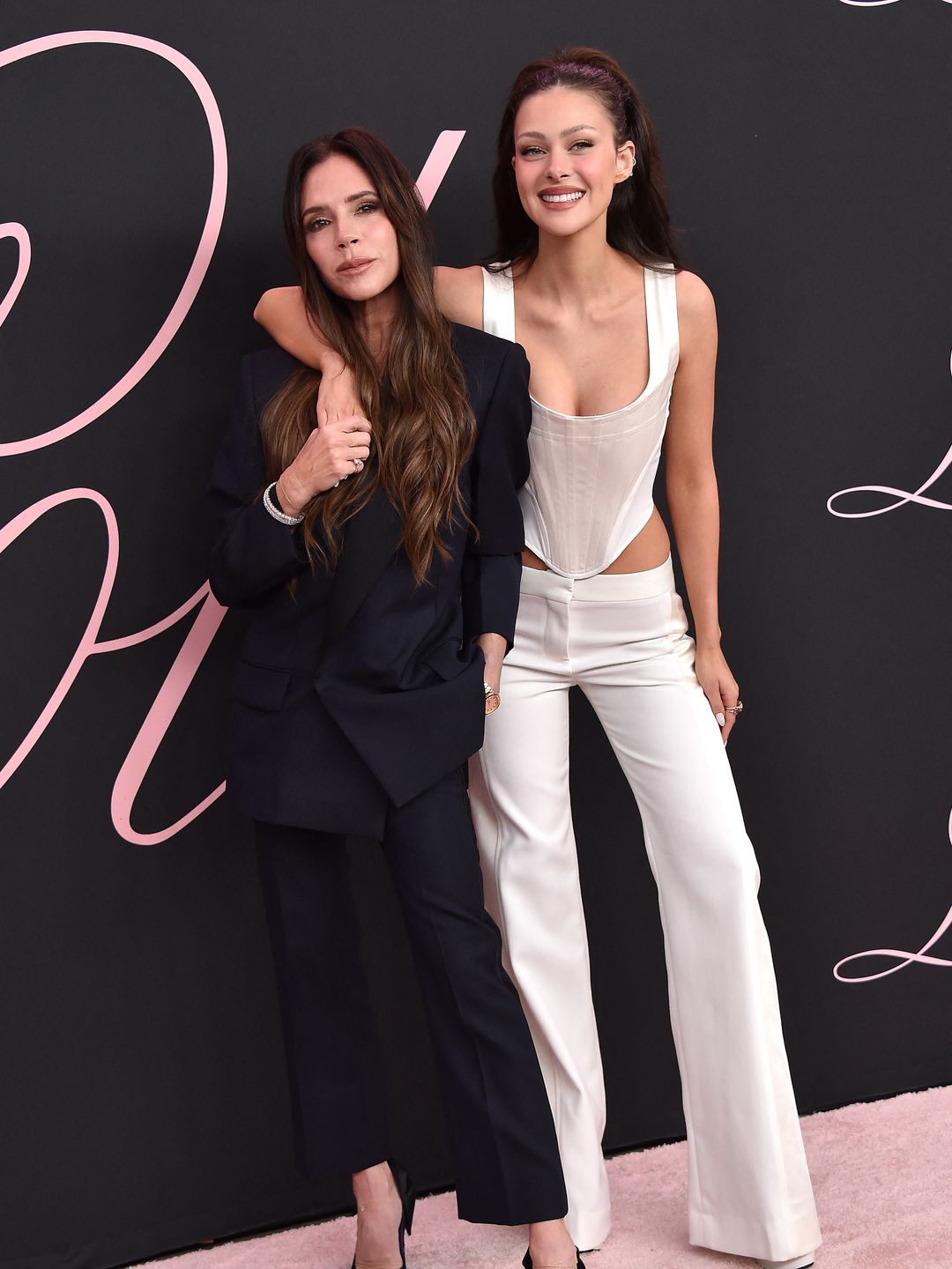 two ladies on pink carpet at premiere 