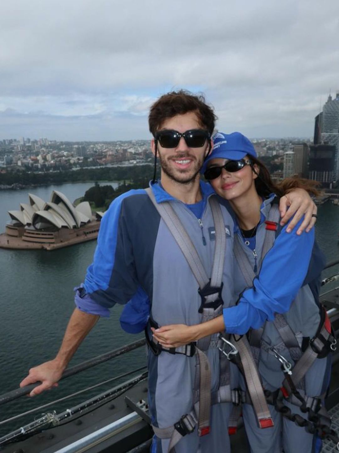 Pierre Gasly and Kika Cerqueira Gomes hugging with the Sydney Opera House in the background