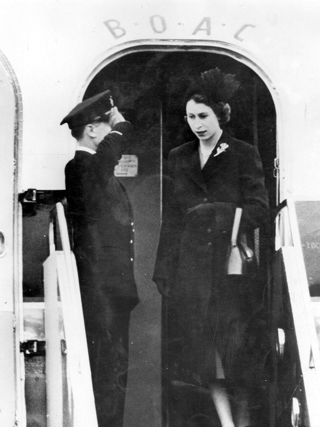 The late Queen getting off a plane in a black dress