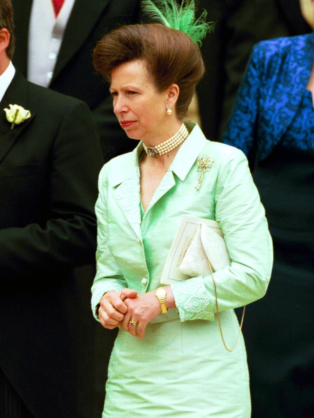 Princess Anne in a green dress with a feather hair accessory
