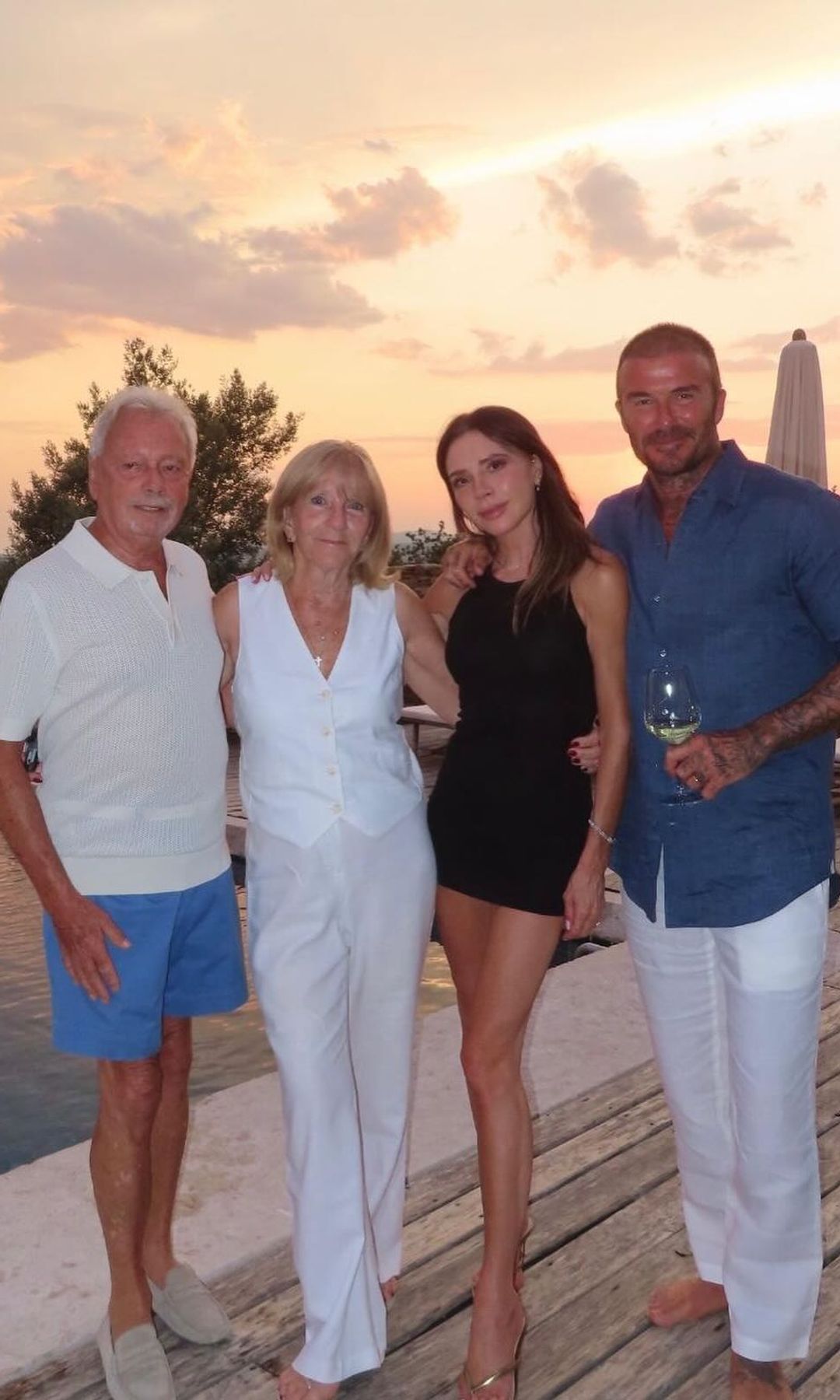 Victoria and David Beckham pose for a photo on holiday