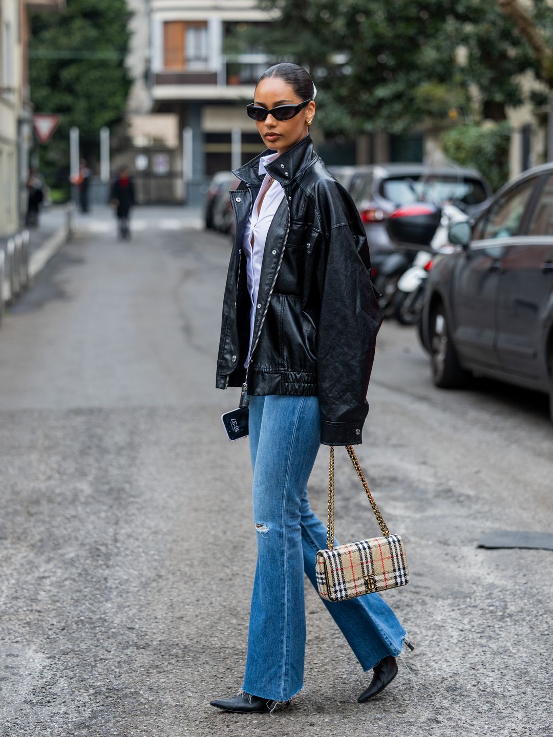 Jamilla Strand wearing flares alongside an oversized jacket and pointed boots 