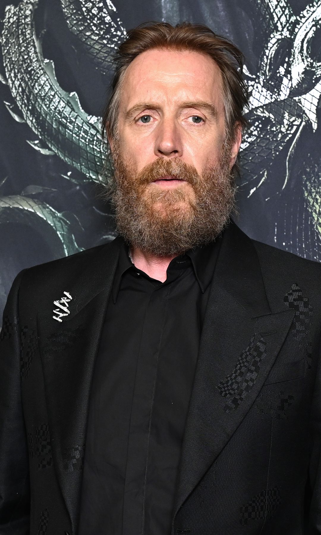 Rhys Ifans in a black suit