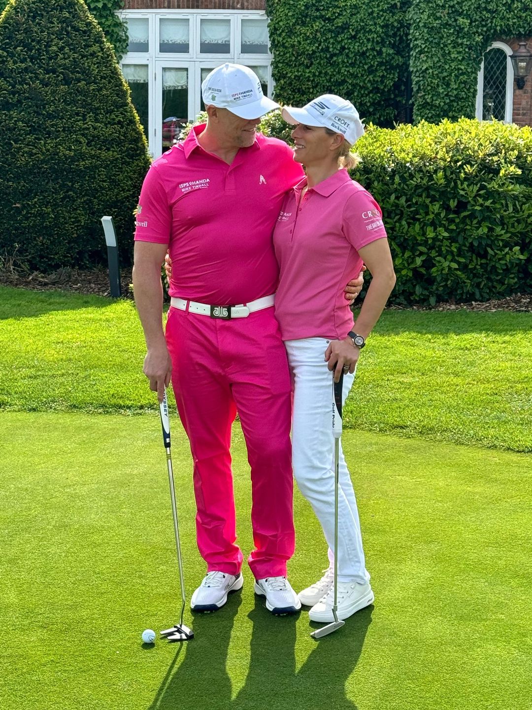 couple hugging in matching pink outfits