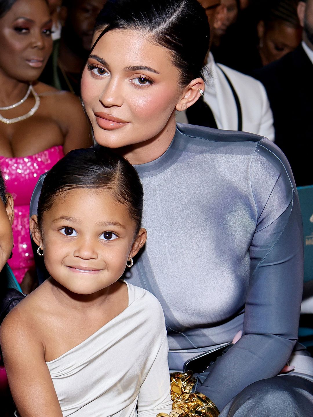 The socialite smiling with her daughter Stormi on her lap at an awards show