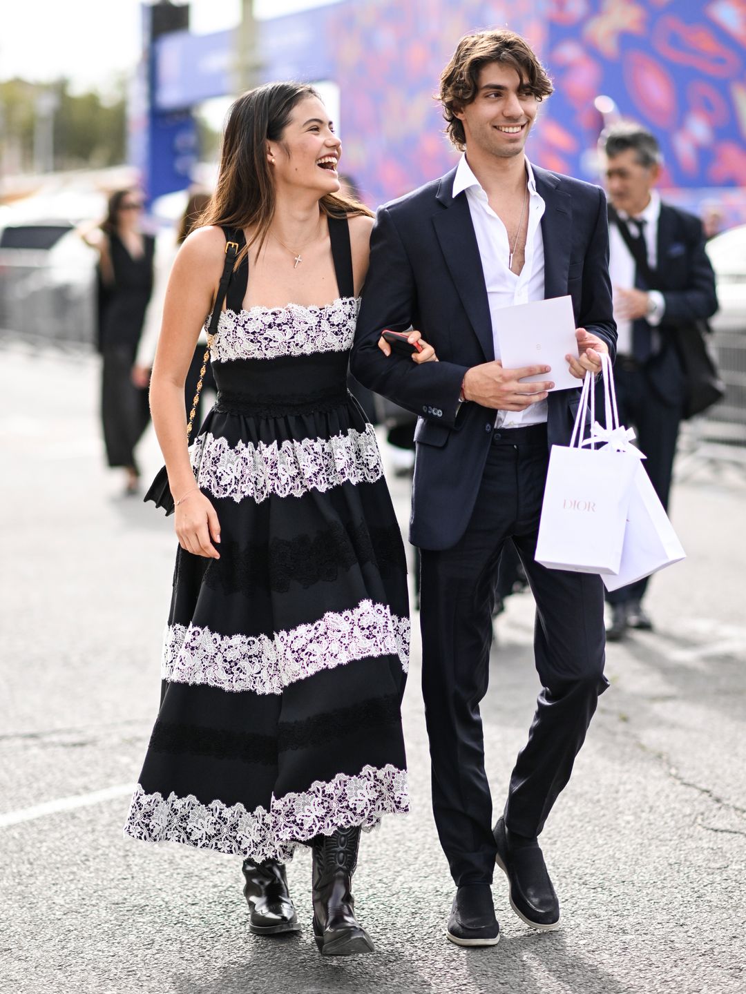 Emma Raducanu is seen wearing a Dior lace black and white dress and black boots with Carlo Agostinelli outside the Dior show during the Womenswear Spring/Summer 2024 as part of Paris Fashion Week