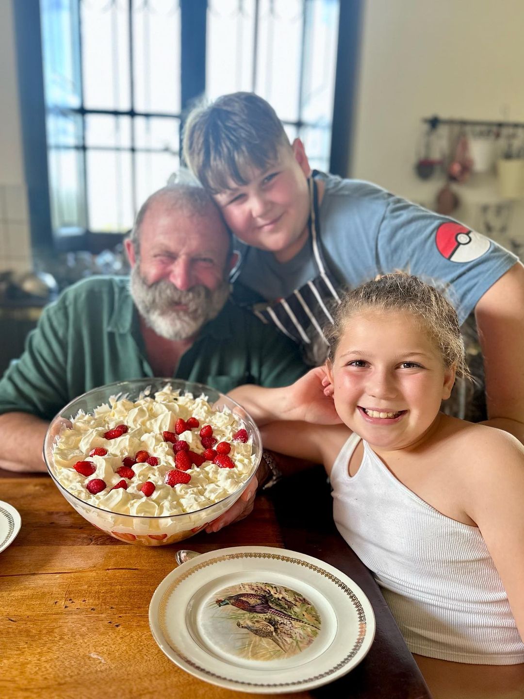 family posing with fruit trifle