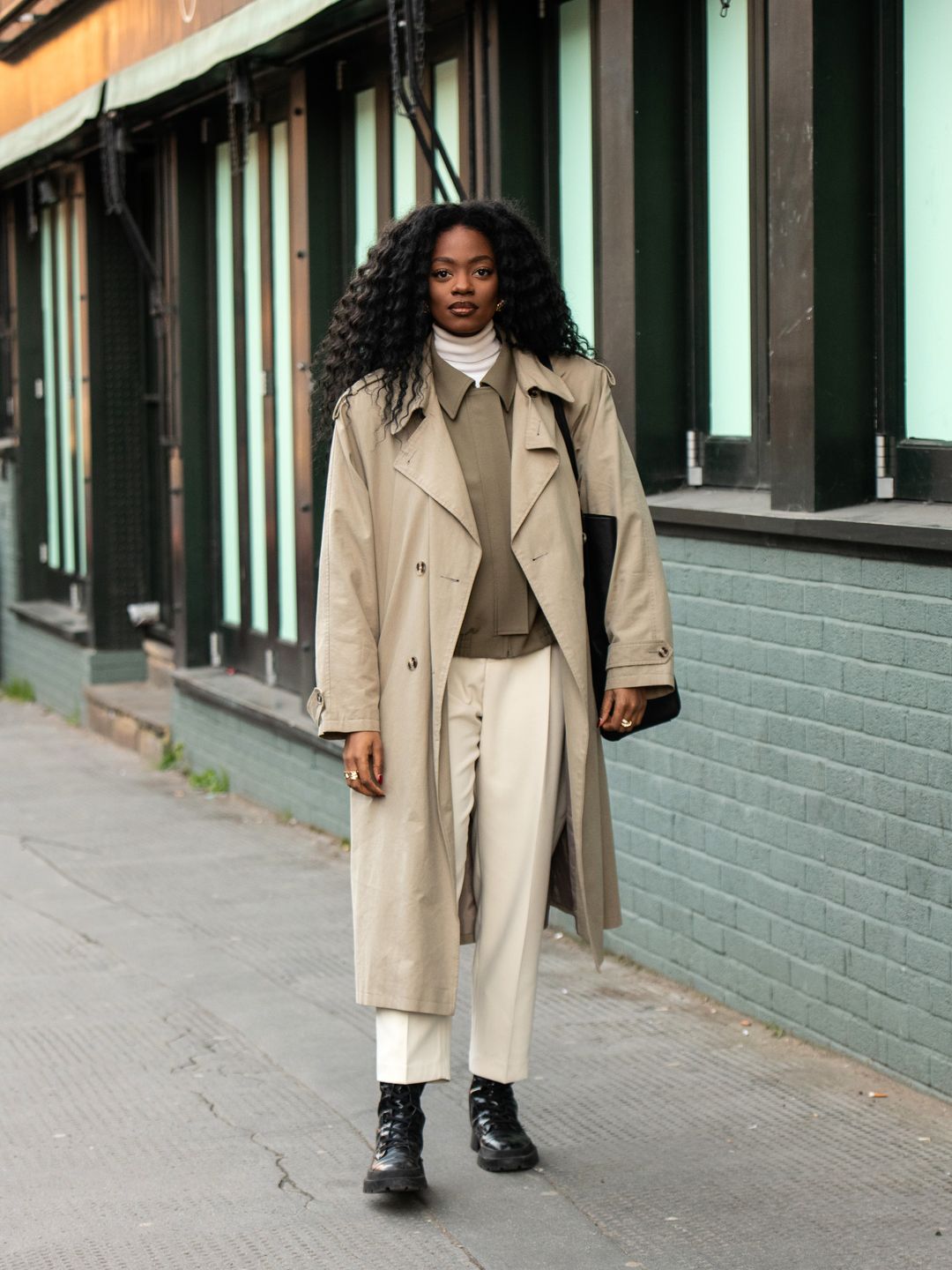 Woman wearing a trench coat with boxy jacket 