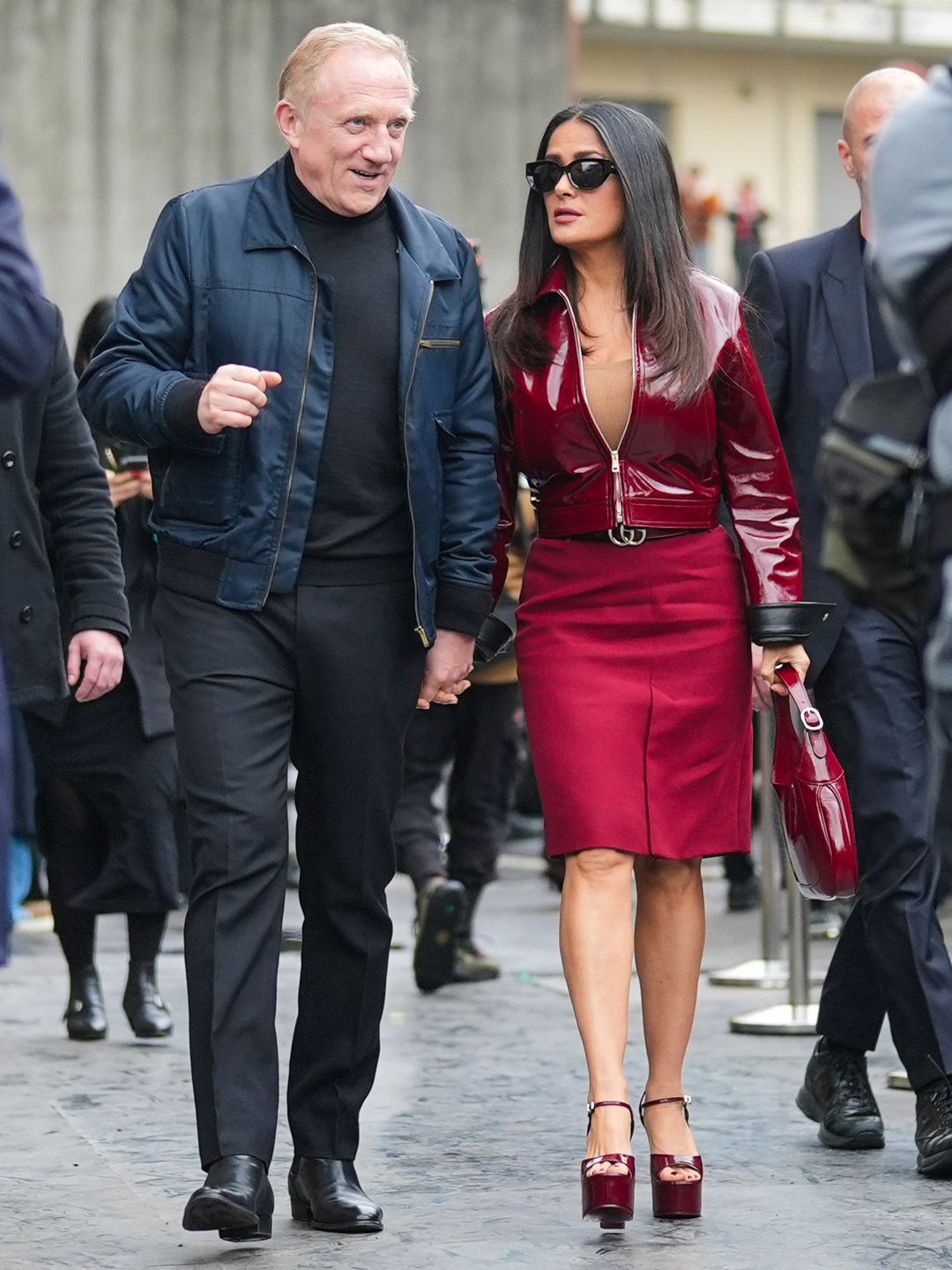 salma hayek and husband arriving at milan fashion week