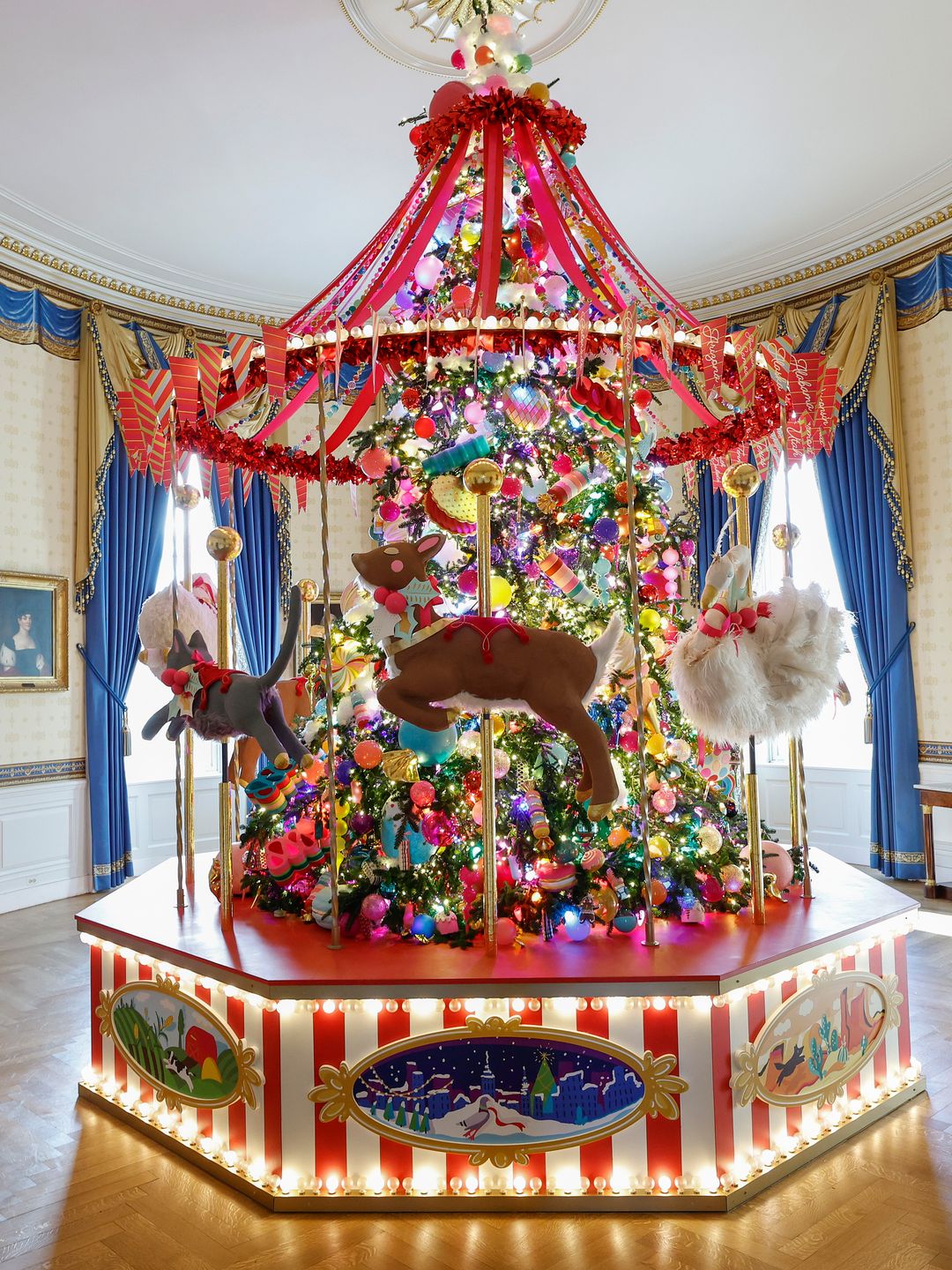 A carousel surrounds the White House Christmas Tree during a media preview of the 2024 holiday decorations at the White House  on December 02, 2024 in Washington, DC. The theme for this year's White House holiday decorations is âSeason of Peace and Light