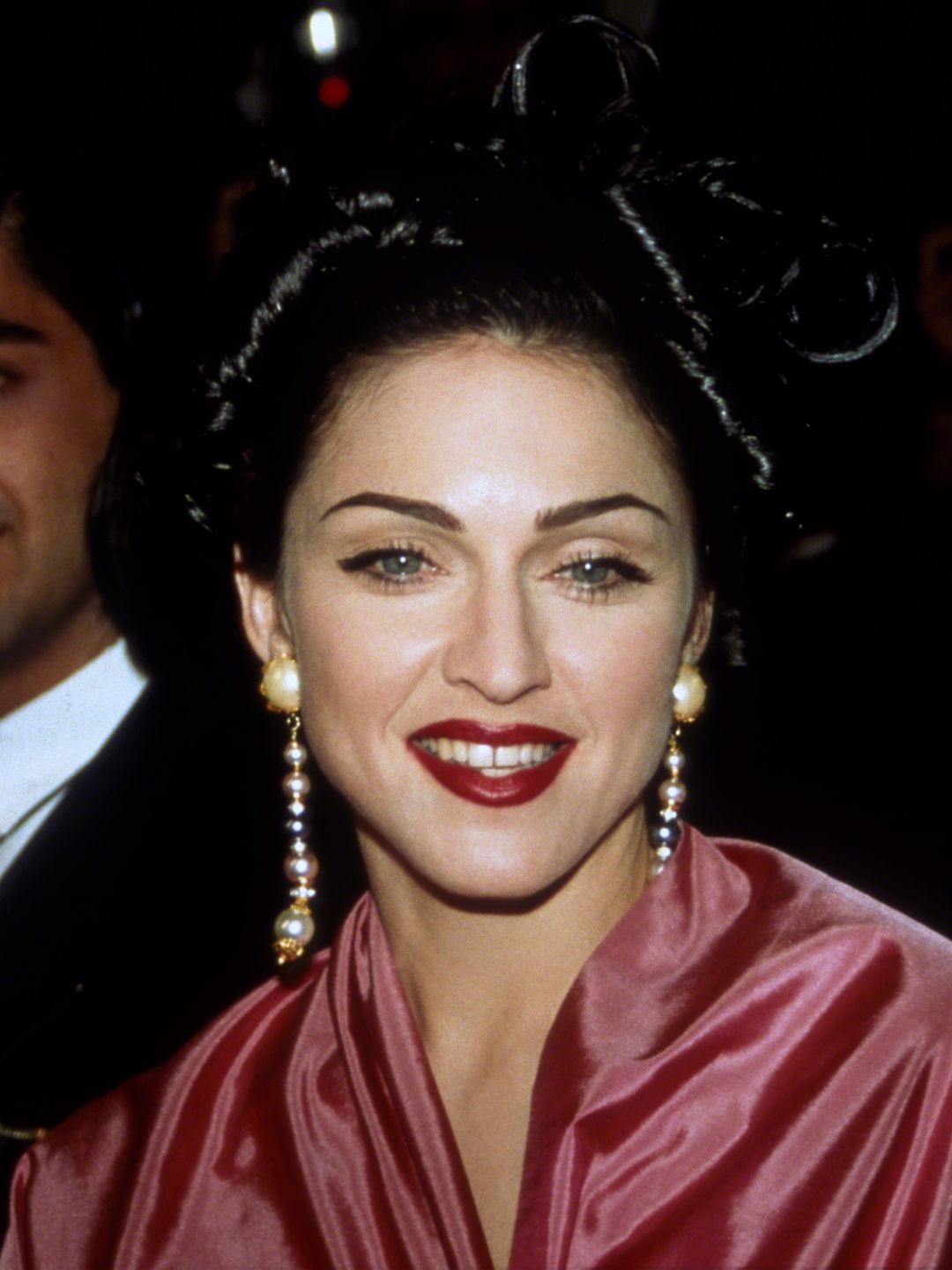 Madonna wearing crimson lipstick and drop down earrings 