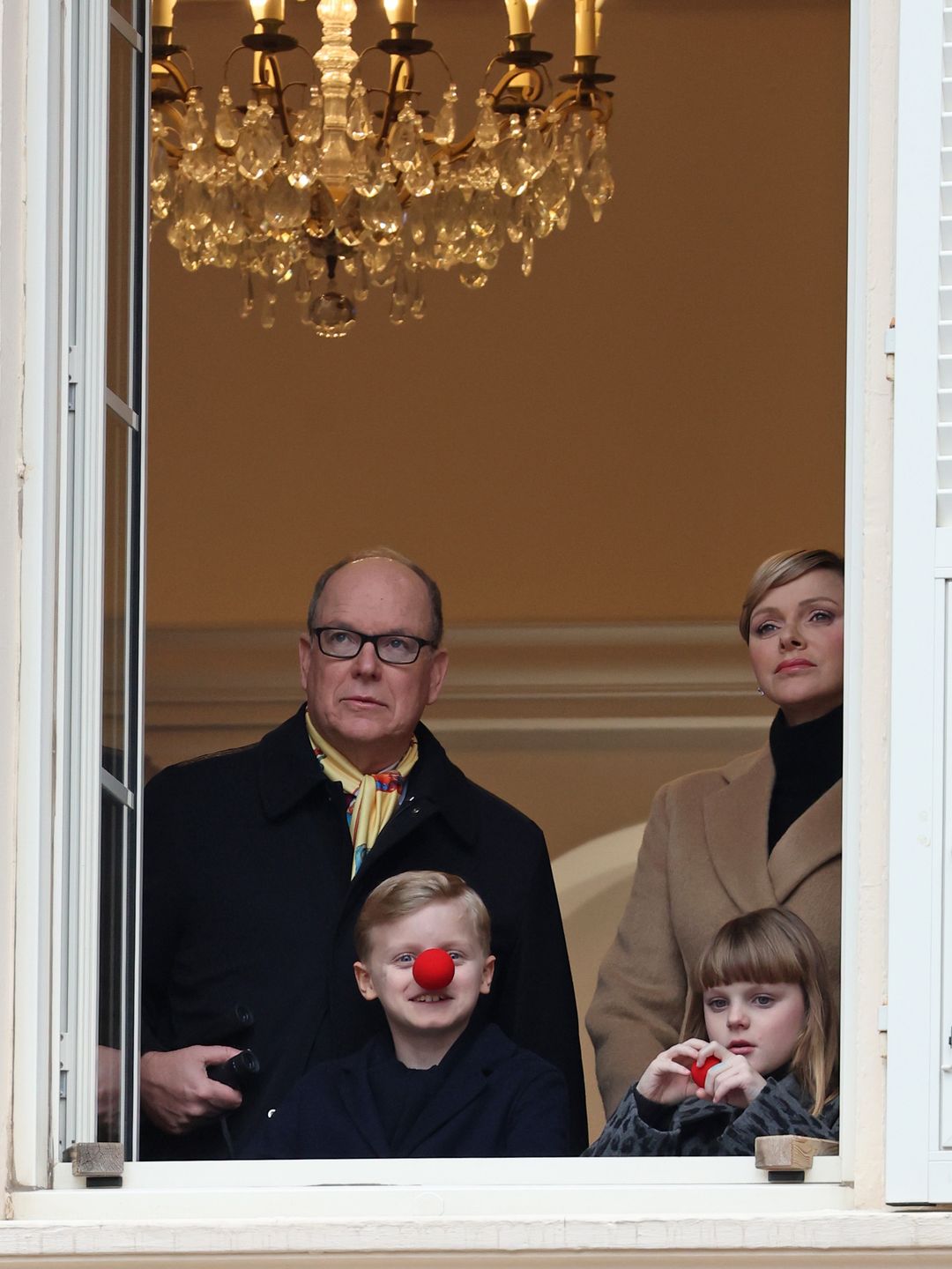 Prince Albert, Princess Charlene and their kids watch as floats, performers, a live band and elephants walk in the Circus Parade