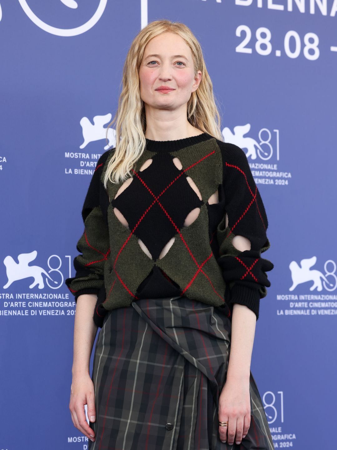 Alba Rohrwacher in a knitted jumper and tartan skirt