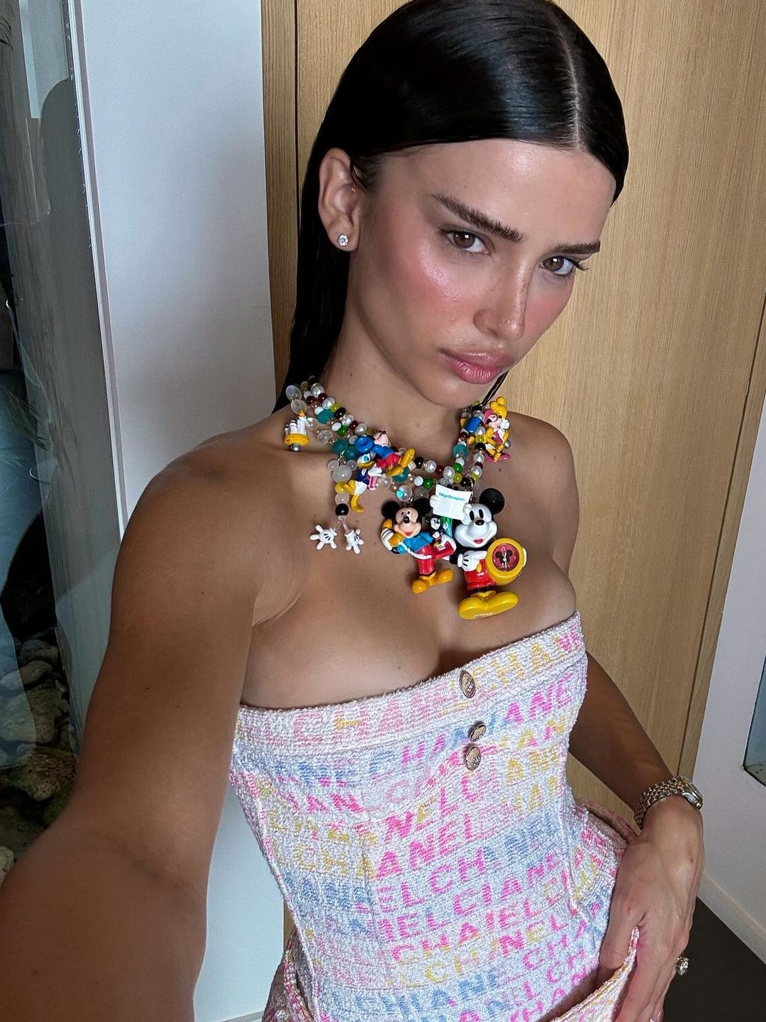 'It' girl Liva Nunes Marques wears a bold charm necklace and Chanel strapless corset and matching mini skirt