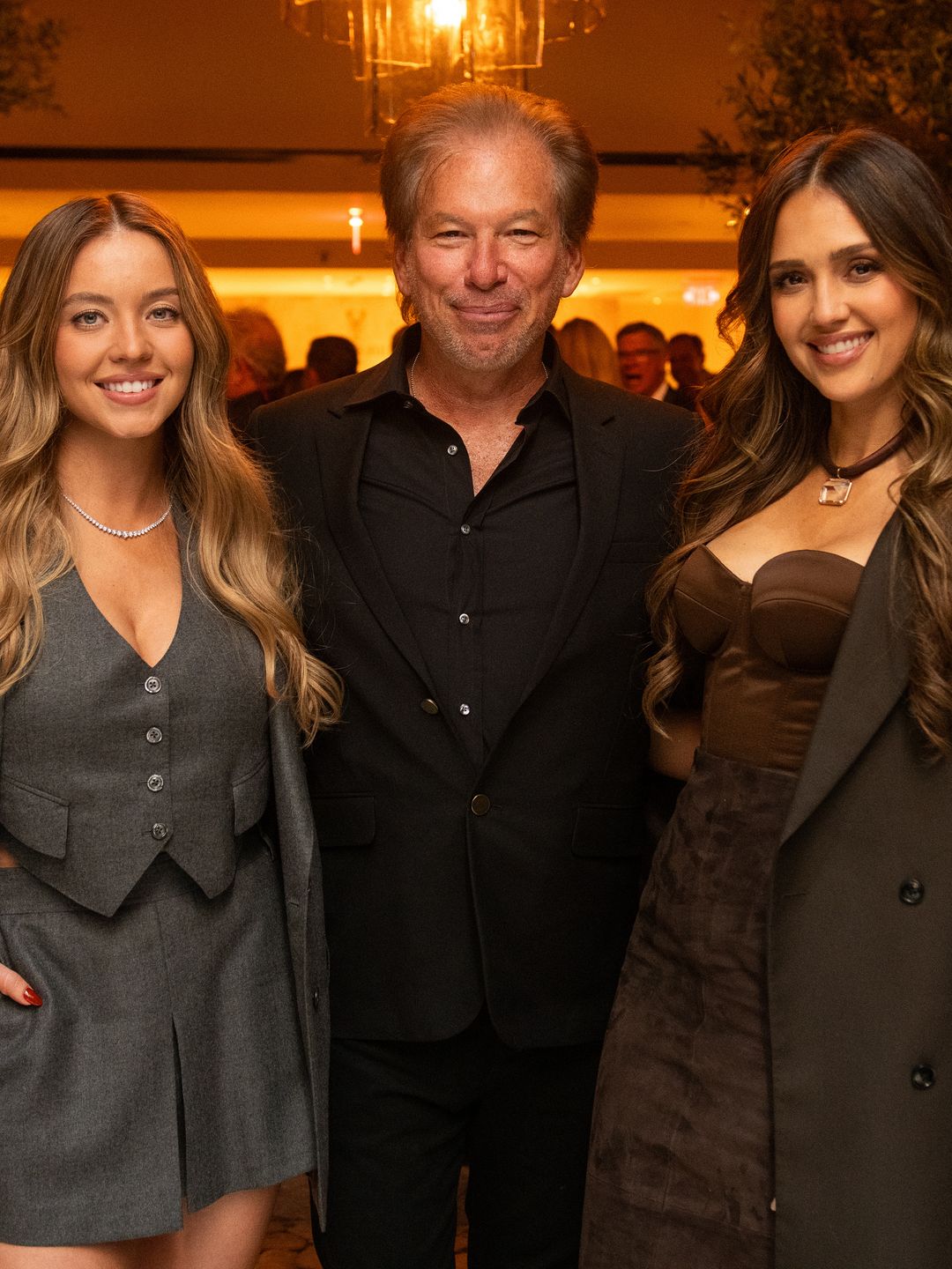 Sydney Sweeney poses for a photo with Gary Friedman and Jessica Alba.