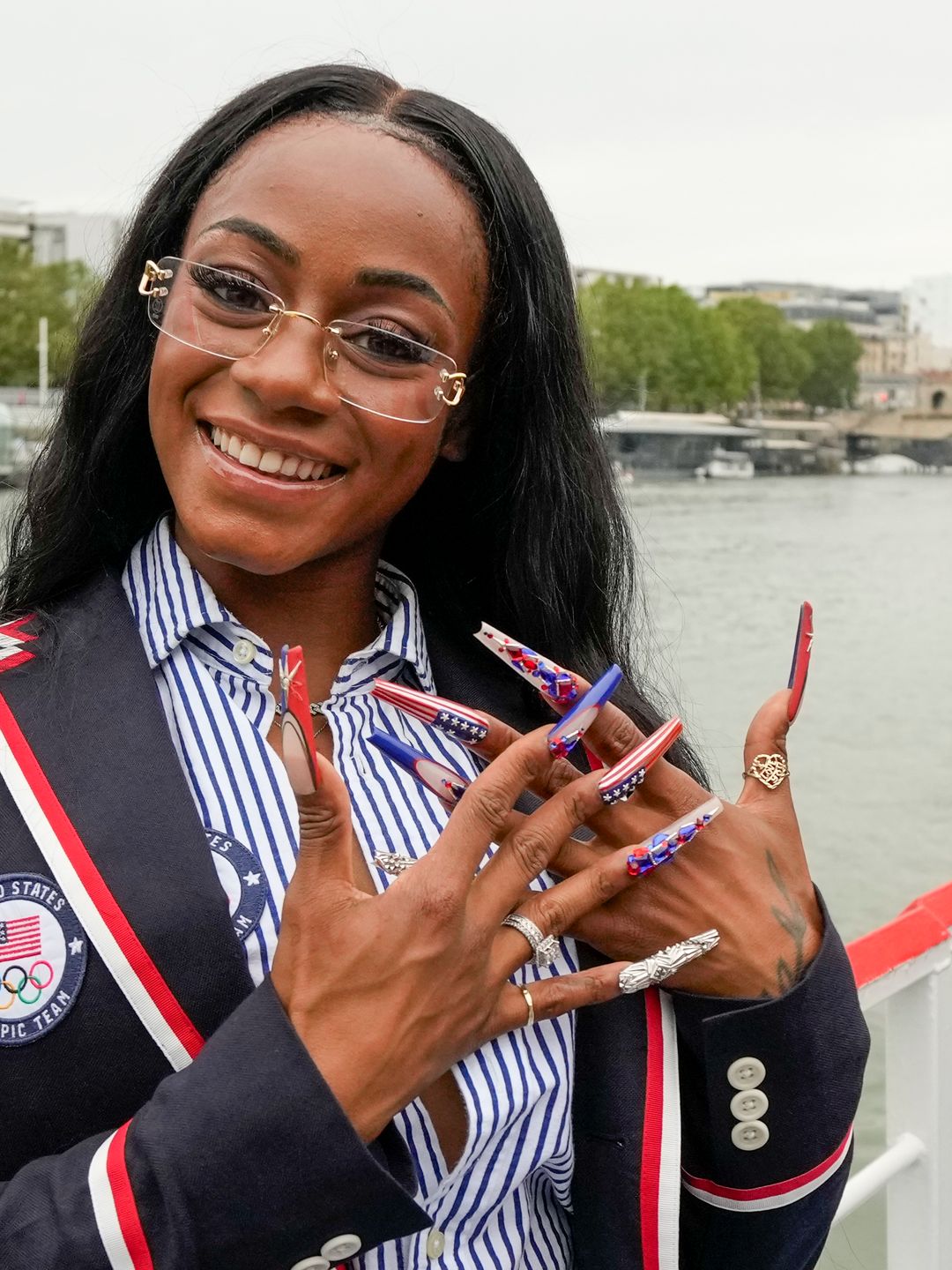  Sha'Carri Richardson poses for a photo while riding with teammates on a boat with teammates along the Seine River during the Opening Ceremony of the Olympic Games Paris 2024