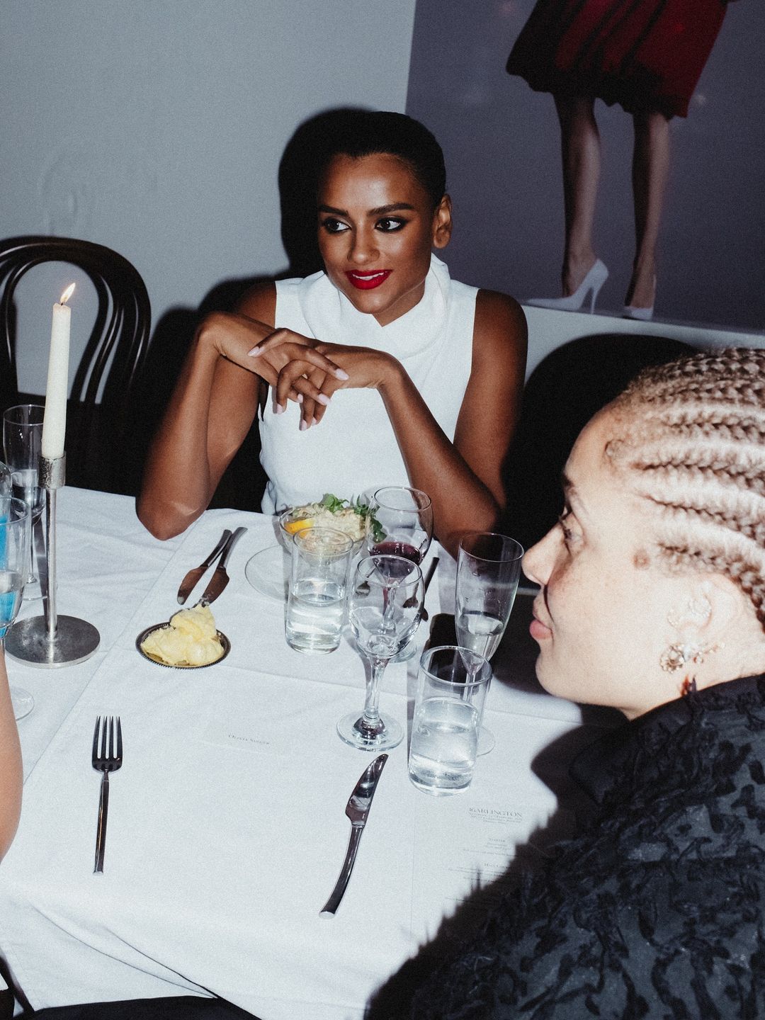 Simone Ashley sits next to model, Adwoa Aboah