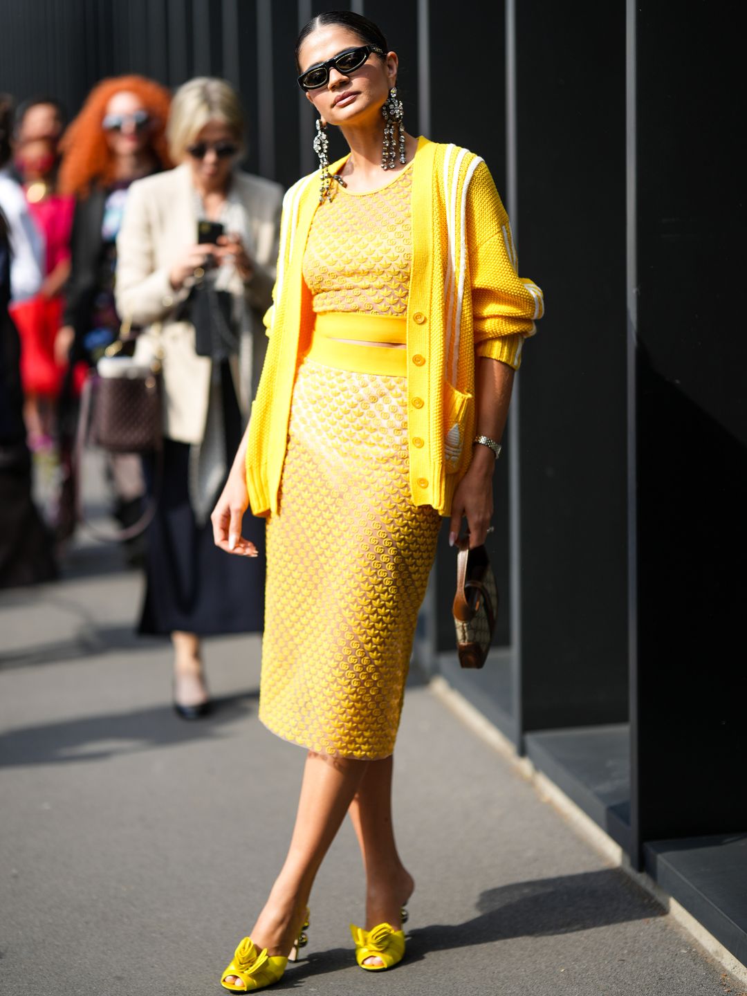 Thassia Naves wearing a yellow co-ord and cardigan 