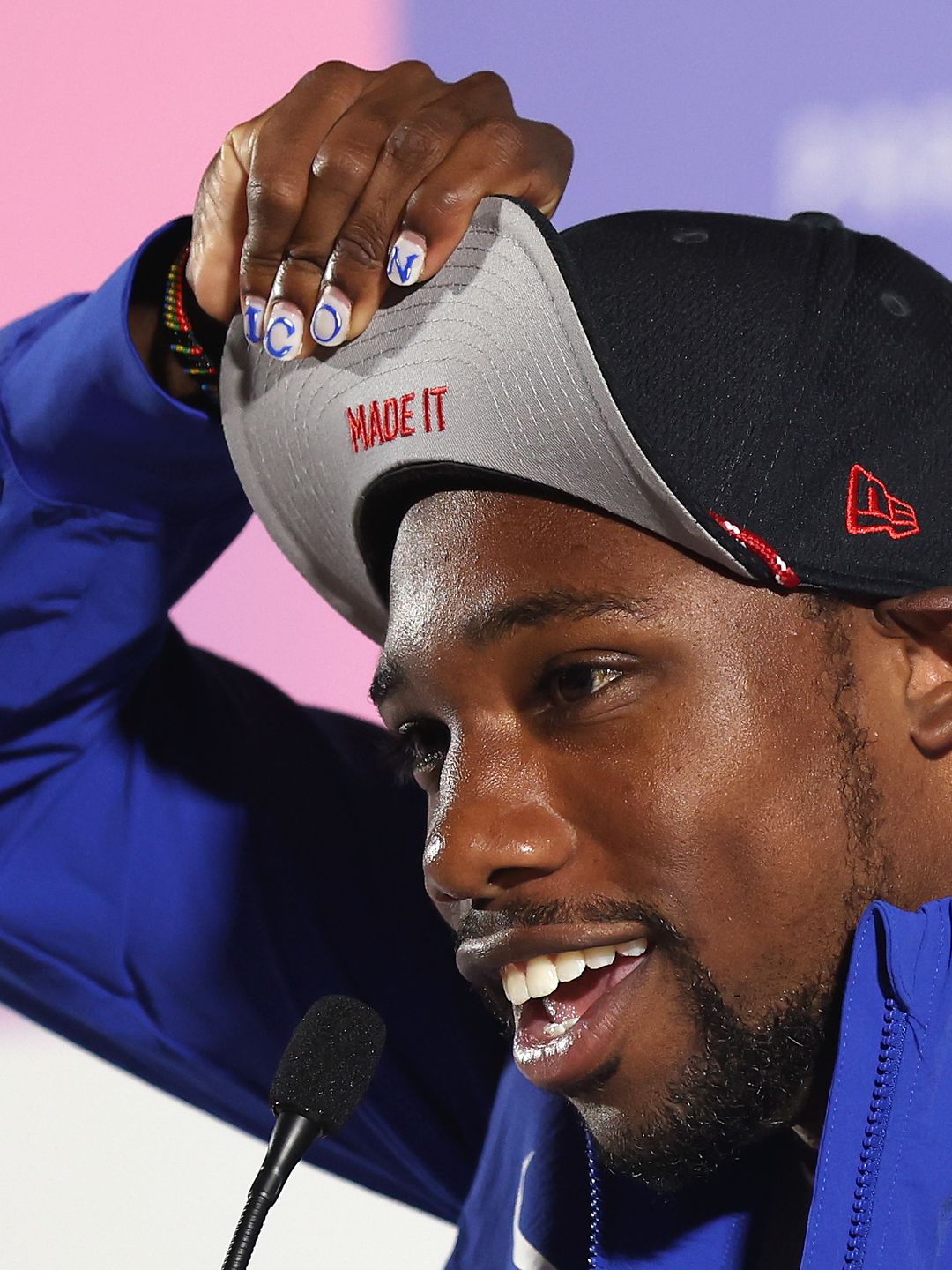 Noah Lyles of the United States shows his "Made It" hat during a Team USA Track & Field press conference on day three of the Olympic Games Paris 2024 