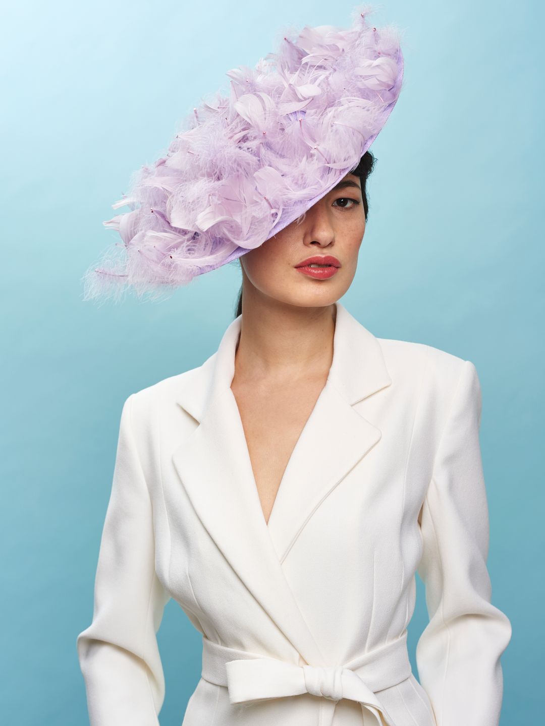 Woman wearing lavender feathered hat 