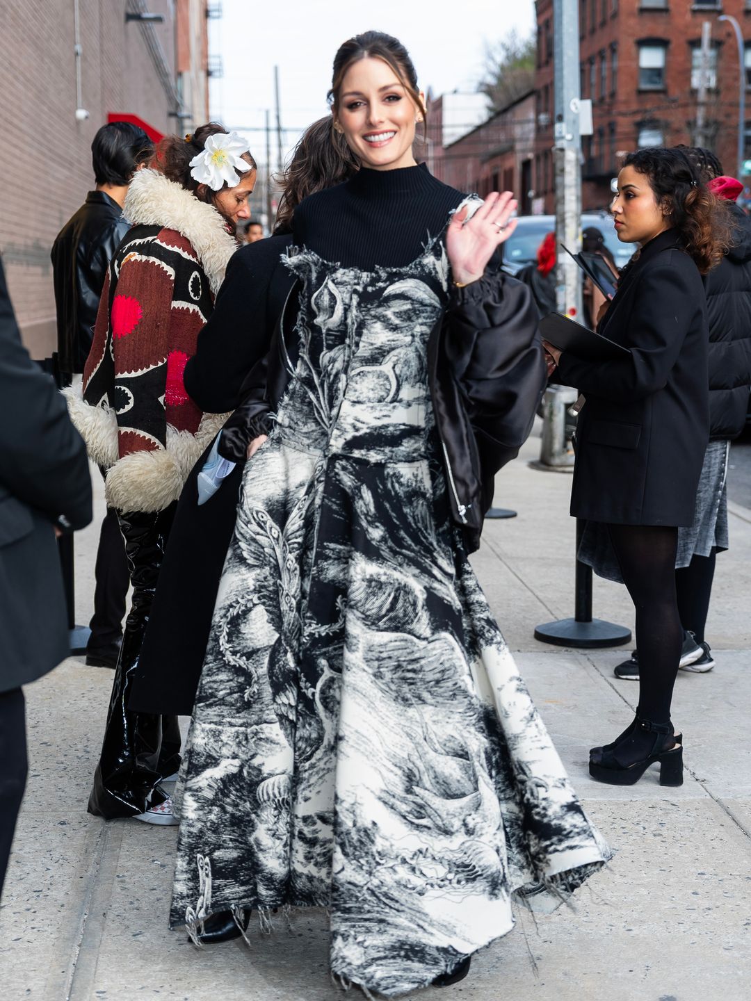 Olivia Palermo attends the Jason Wu show in a striking black and white printed gown styled over a knitted turtleneck.